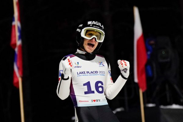 Timon-Pascal Kahofer (16) of Austria celebrates his jump during the individual normal hill Ski Jumping trial round at the World University Games on January 15, 2023 in Lake Placid, New York. He won the bronze medal.  (Photo by Porter Binks/FISU Games)
